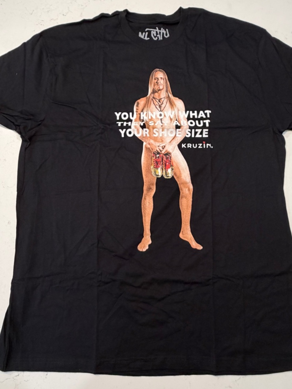 Black Graphic Tee with Nude Figure and Shoe Print